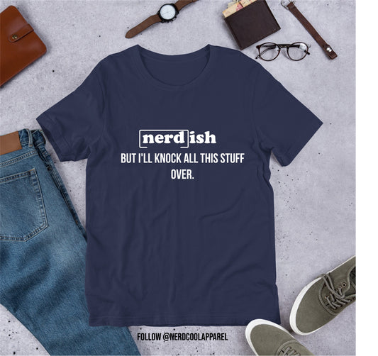 Navy blue t-shirt with 'nerd ish' text on a gray surface with casual items.