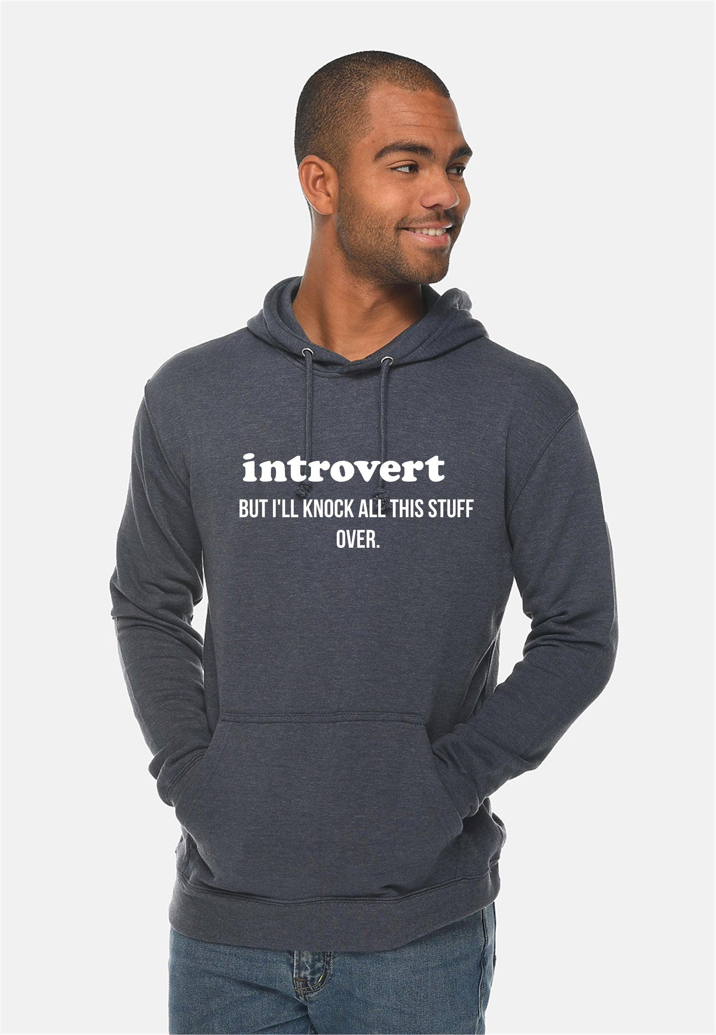 Man wearing a hoodie with 'introvert but I'll knock all this stuff over' text on a white background