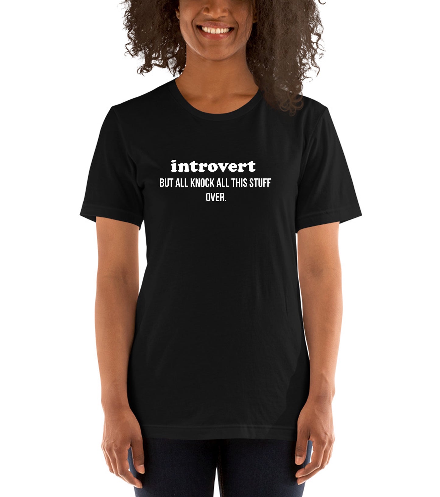 Person wearing a black t-shirt with 'introvert BUT ALL KNOCK ALL THIS STUFF OVER.' text.