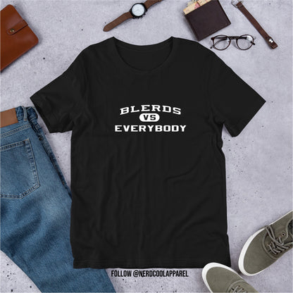 Black t-shirt with 'BLERDS VS EVERYBODY' text on a gray surface with jeans, shoes, and accessories.