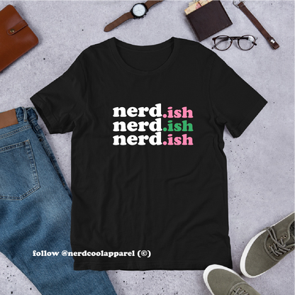 Black t-shirt with 'nerd.ish' text in different colors on a concrete surface with casual items.