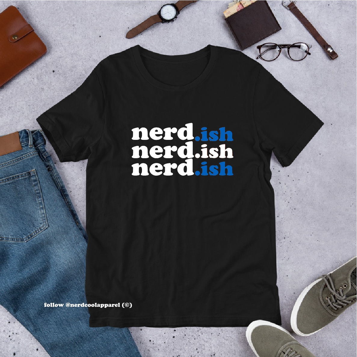 Black t-shirt with 'nerd.ish' text on a gray surface with casual items around