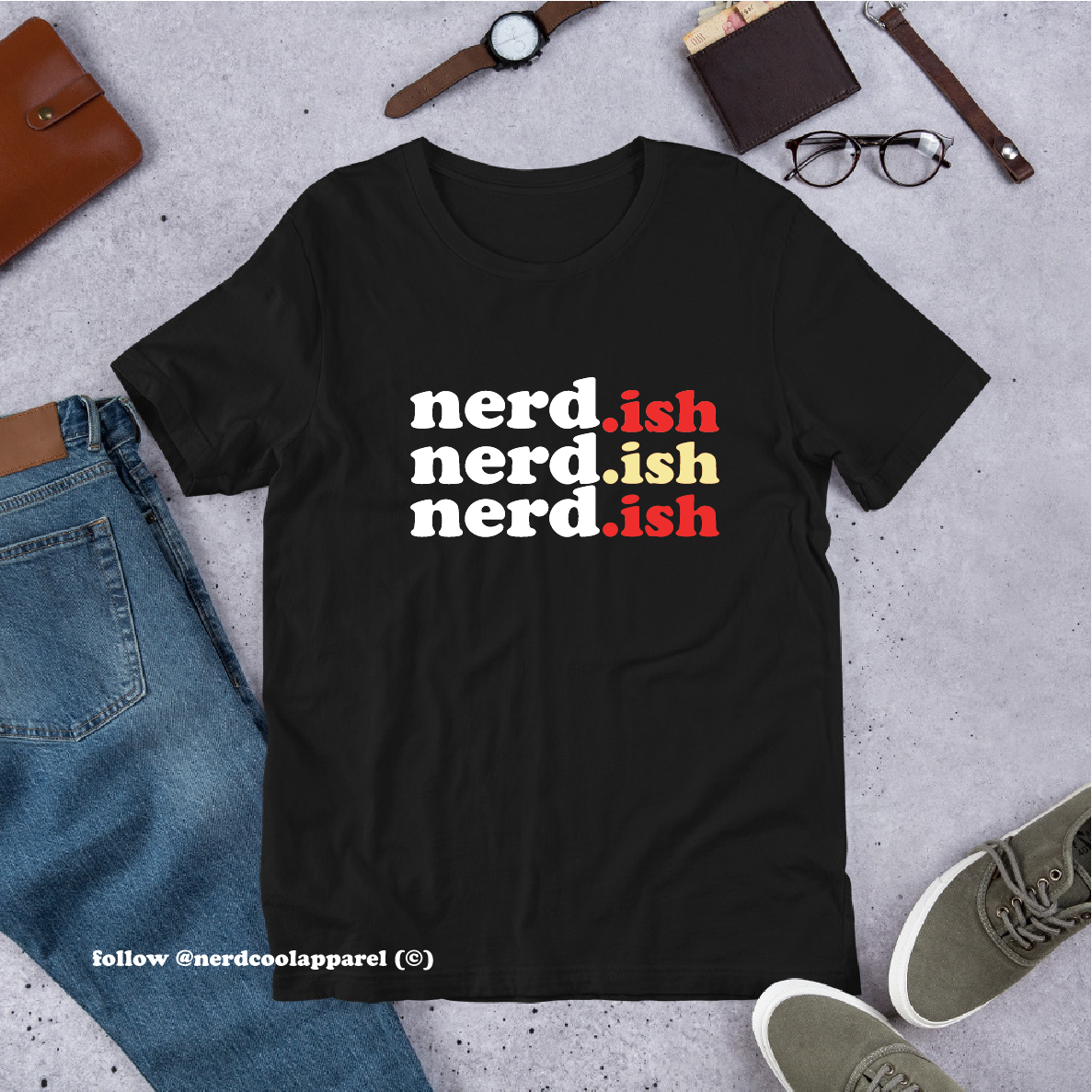 Black t-shirt with 'nerd.ish' text on a gray surface with casual items around