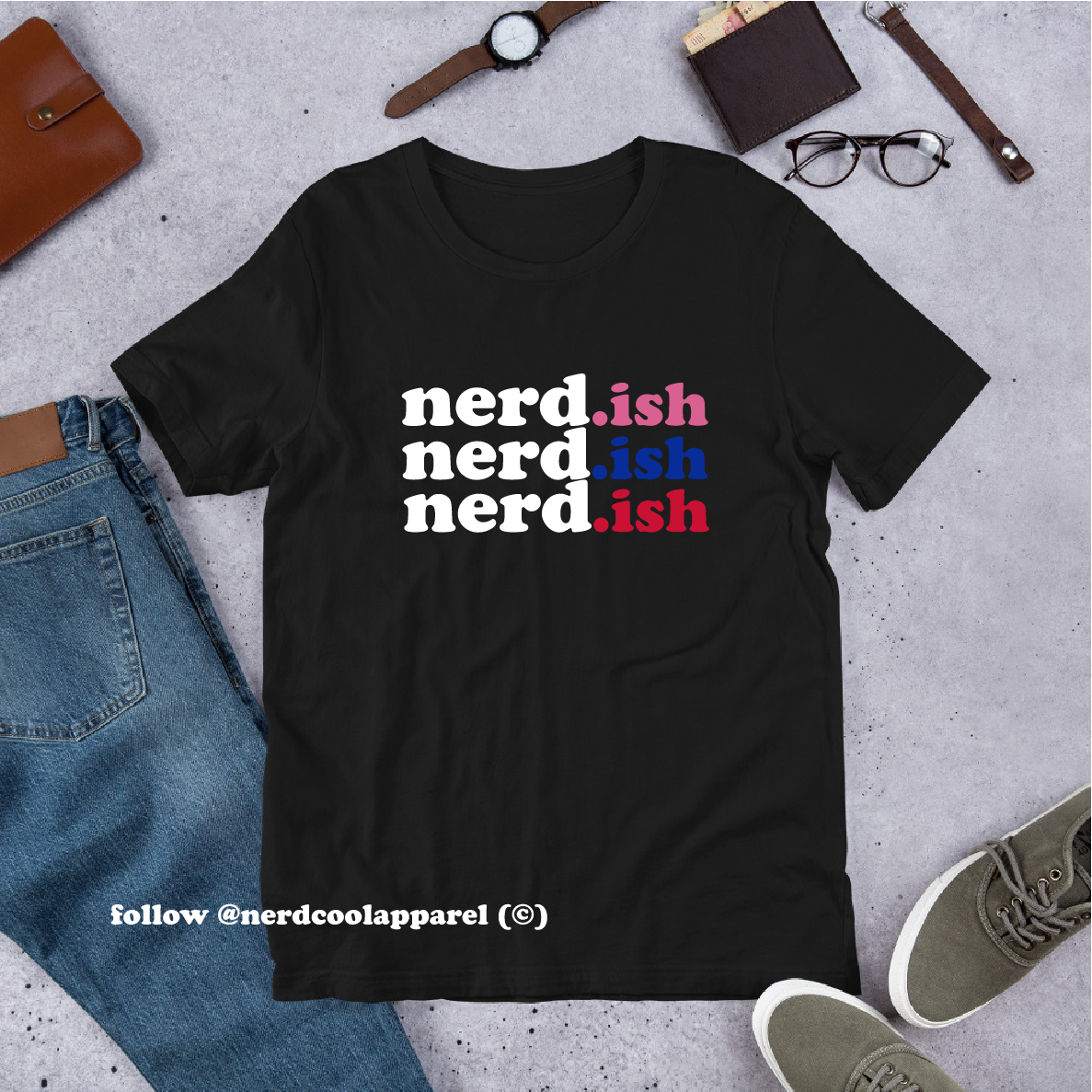 Black t-shirt with 'nerd.ish' text on a gray surface with casual items around