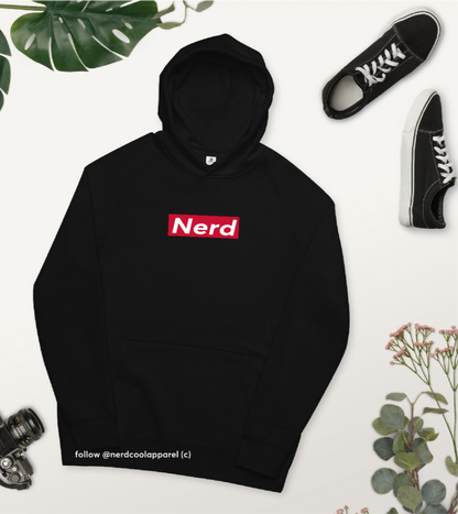 Black hoodie with 'Nerd' logo on a light background with sneakers and plants.