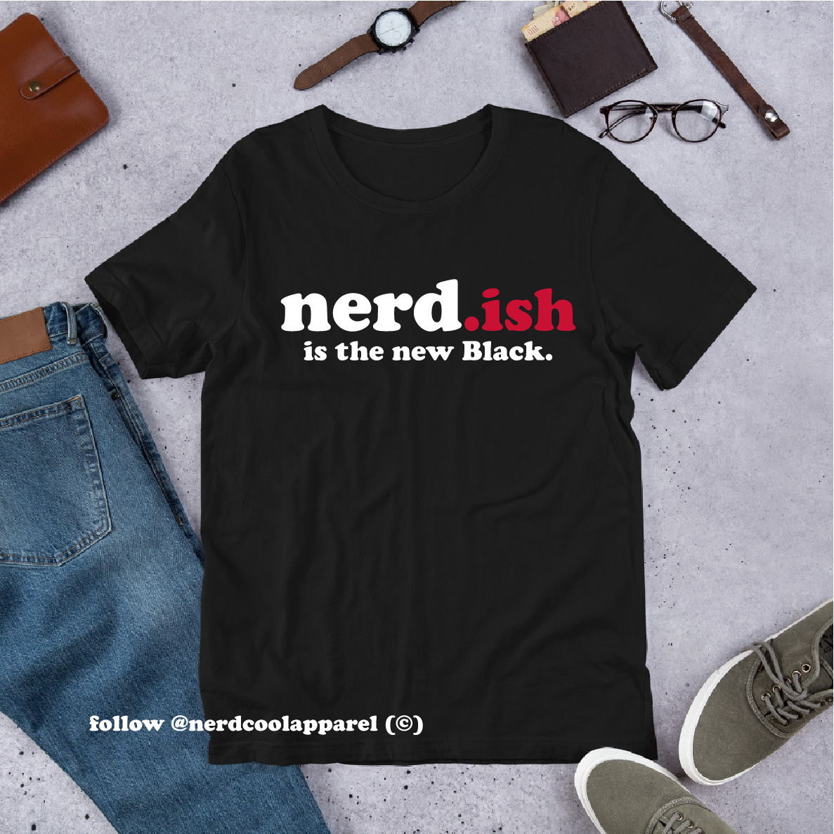 Black t-shirt with 'nerd.ish is the new Black' text on a concrete surface with casual items.