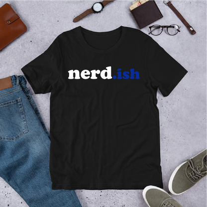 Black t-shirt with 'nerd.ish' text on a gray surface with jeans, shoes, and accessories.