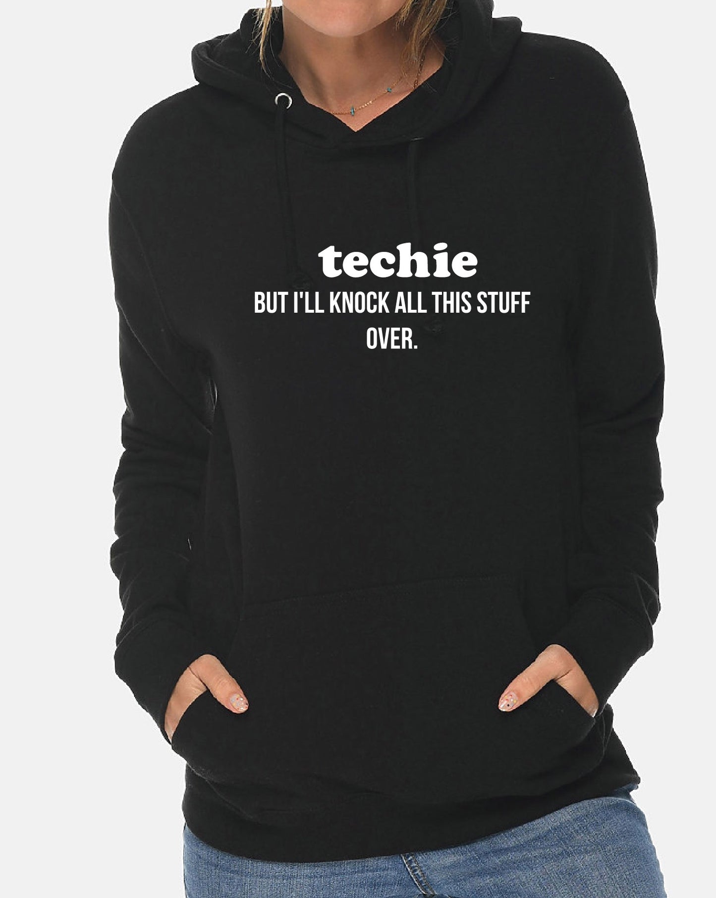 Black hoodie with text 'techie BUT I'LL KNOCK ALL THIS STUFF OVER.' on a plain background