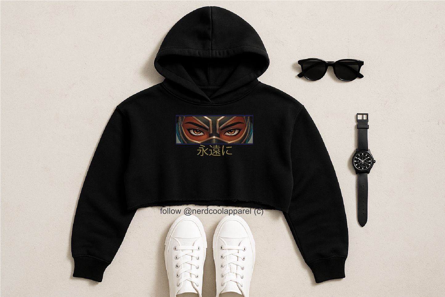 Black hoodie with a mask design, white sneakers, sunglasses, and watch on a beige background