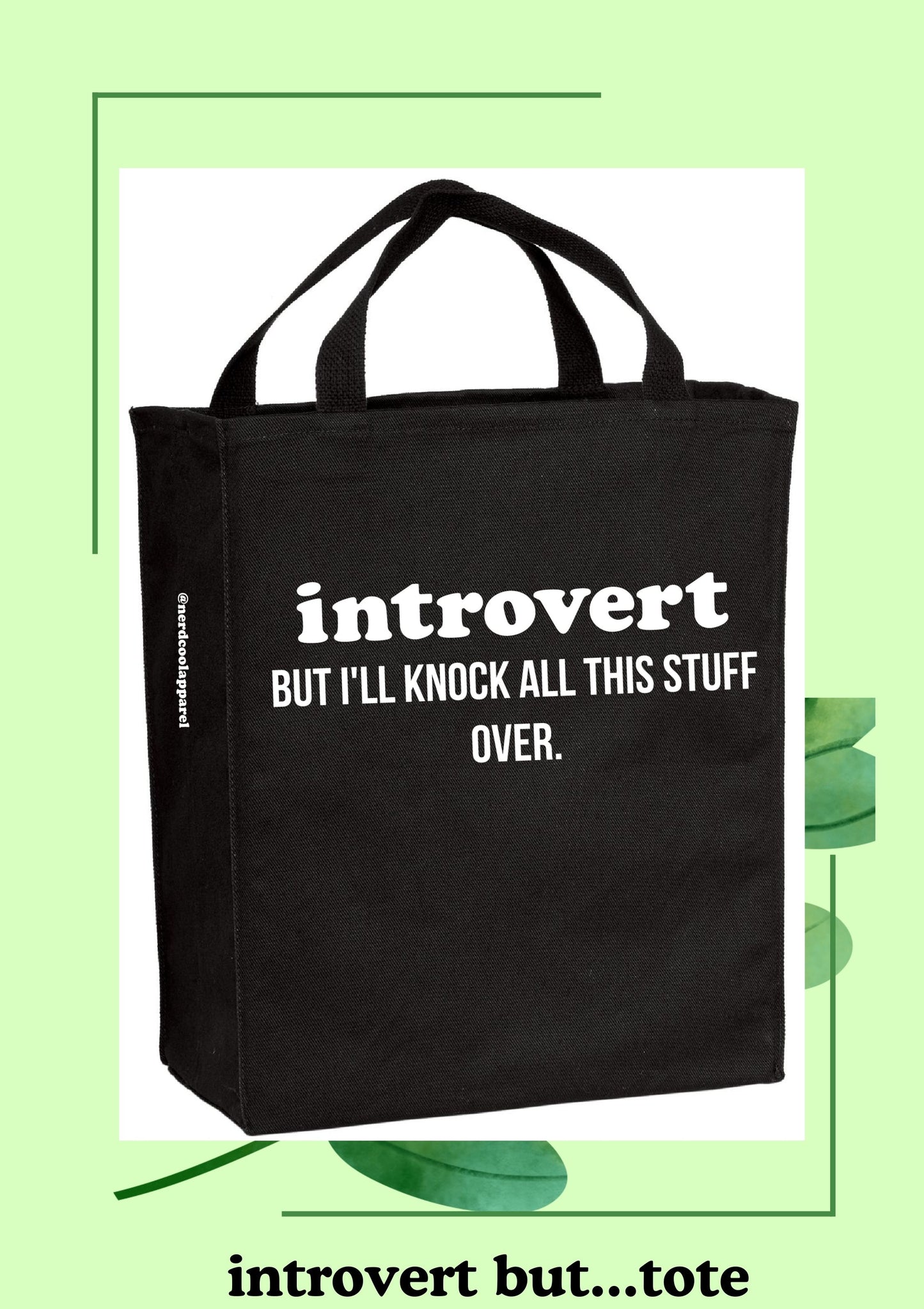 Black tote bag with 'introvert but I'll knock all this stuff over' text on a light green background