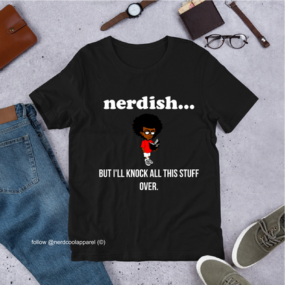 Black t-shirt with 'nerdish...' text and cartoon character, surrounded by jeans, shoes, and accessories on a gray surface.