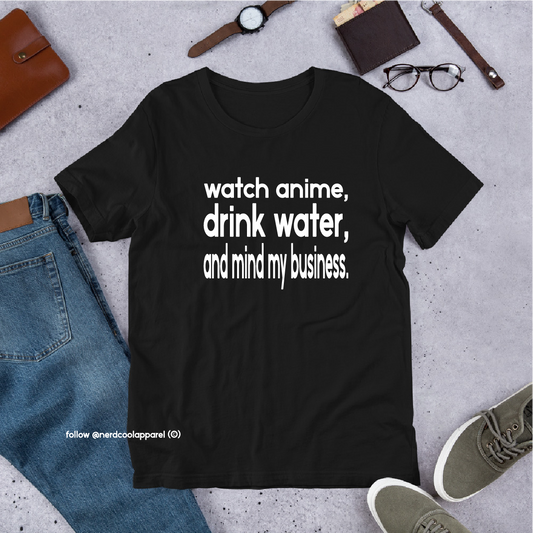 Black t-shirt with text 'watch anime, drink water, and mind my business' on a gray surface with casual items.